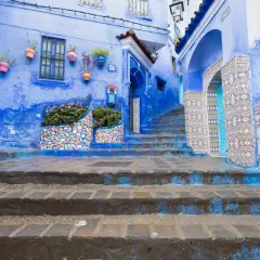 Niebieskie miasto w Maroku, Chefchaouen, zachwyca kolorowymi mozaikami i kwitnącymi roślinami.