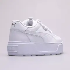 Białe buty na platformie Puma Karmen Rebelle Jr. z czarnym logo.