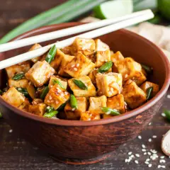 Kawałki tofu w sosie, posypane sezamem i szczypiorkiem, gotowe do podania. Idealna marynata do tofu!