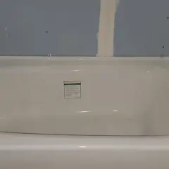 Installing cement board around a tub is underway. The tub is in place, and the blue drywall is being prepped for the next steps.