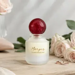 Elegancka klasyfikacja perfum: flakon "Merger Galaxy Collection" z różami, szpilkami i obrączkami.