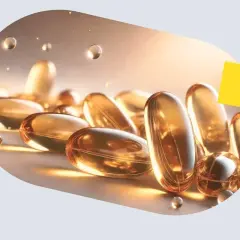 Złote kapsułki omega-3 zarejestrowane jako lek pan tabletka, lśniące w świetle.