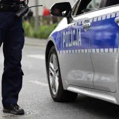 Policjant stoi obok radiowozu. Czy policja może namierzyć wyłączony telefon? To pytanie, na które odpowiedź może być kluczowa w śledztwie.