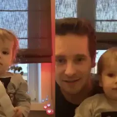 Nicola Zalewski tata z synkiem. Uśmiechnięty ojciec trzyma dziecko, które bawi się słuchawką telefonu.