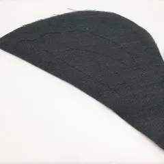 A dark gray fabric piece, shaped like a wing, shows stitching lines that form a shoulder pad pattern.