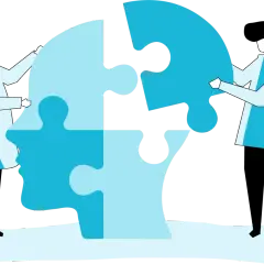 Dwie osoby składają puzzle w kształcie głowy, symbolizując terapię behawioralną i proces zrozumienia siebie.
