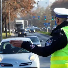 Policjant kieruje ruchem na ulicy. Kierowca zatrzymuje się, bo zgubił prawo jazdy i boi się kontroli.