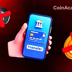 Main d'une personne tenant un smartphone affichant un virement bancaire bloqué. Des symboles de croix rouges sur des pièces suggèrent un problème avec les transactions N26.