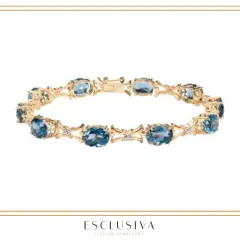 Złota bransoletka z niebieskimi kamieniami i diamentami. Taka żółta bransoletka symbolizuje elegancję i luksus.