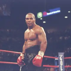 Mike Tyson in the ring, ready to fight. His physique hints at the incredible strength needed to know how much Mike Tyson could bench.