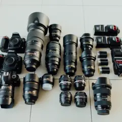 Nikon cameras and lenses laid out, a photographer's dream. Choosing the right camera depends on your needs, from portraits to landscapes.