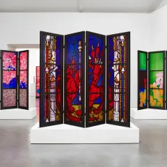 A triptych of stained glass screens, showcasing vibrant floral and mythical scenes, reminiscent of the work of famous stained glass artists.