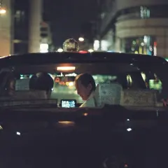 Taxi driver illuminated by a phone screen, a perfect shot for the best 35mm film for low light.
