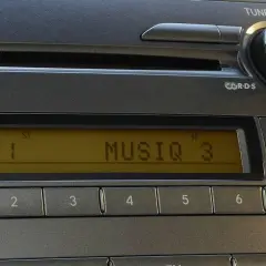 Radio samochodowe z wyświetlaczem RDS, pokazującym FM1 i MUSIQ 3. Przyciski numeryczne i sterowanie audio.