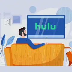 Mężczyzna z kotem relaksuje się na kanapie, oglądając Hulu Polska.