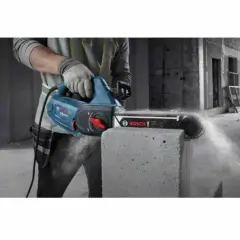 Ręczna piła łańcuchowa Bosch do cięcia obrzeży betonowych, generująca pył.