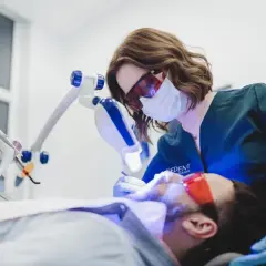 Dentystka wykonuje higienizację zębów w ciąży, dbając o zdrowy uśmiech przyszłej mamy.