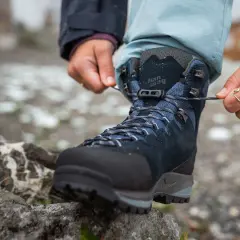 Lacing up new hiking boots. Wondering how long to break in shoes for comfort on the trail.