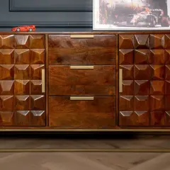 A geometric carved mango wood finish sideboard with brass handles and a gold metal base.