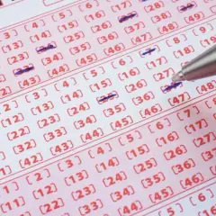 Długopis zaznacza liczby na kuponie lotto. Czy wygrana w zdrapkę online jest tak samo opodatkowana jak ta papierowa?