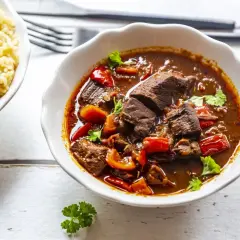 Gęsty, aromatyczny gulasz po zbójnicku z kawałkami mięsa i papryką, podany z ryżem.