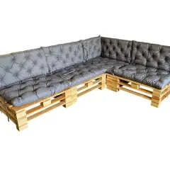 Narożnik z palet jak zrobić? Prosty projekt DIY: drewniane palety i wygodne szare poduchy tworzą stylowy mebel ogrodowy.