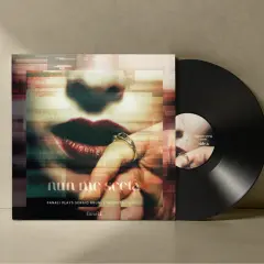 Vinyl record with album cover featuring a close-up of lips and a hand with rings.