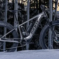 A **Giant Yukon mtn bike** with fat tires sits in the snow, ready to conquer winter trails.