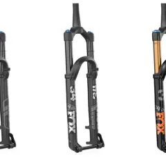 Three Fox suspension forks: two black Performance models and one black Factory model with gold stanchions, showcasing the difference between Fox Factory vs Performance.