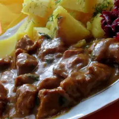 Gulasz z łopatki wieprzowej w sosie własnym, podany z ziemniakami i buraczkami. Pyszne, domowe danie.