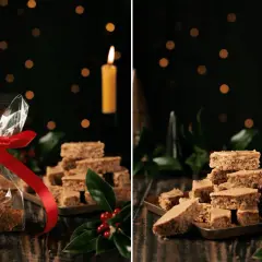 Weihnachtliche Elisenlebkuchen vom Blech, liebevoll verpackt und auf einem Blech gestapelt, mit Kerzenlicht und Tannenzweigen.