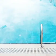 Ein Frame Pool mit glitzerndem Wasser und einer Leiter lädt zum Schwimmen ein.