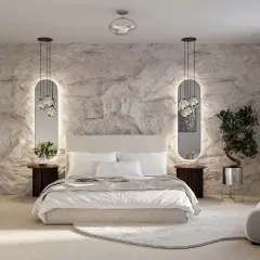 Moderne Schlafzimmer Style Ideen: Steinwand, Spiegel mit Beleuchtung, bequemes Bett und ein Olivenbaum im Topf schaffen eine luxuriöse Atmosphäre.