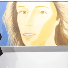 A man in a suit admires a large painting of a woman's face at Art Basel Hong Kong 2026.
