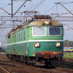 Zielona lokomotywa ET40-35-A na torach, w tle inne pociągi i sieć trakcyjna.