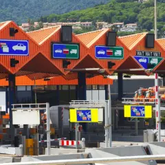 Carriles de peaje con señales que indican cómo pagar. Hay señales para coches y camiones, y una para pago manual.
