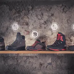 Five pairs of boots displayed on a shelf, showcasing the differences between mountaineering boots vs hiking boots. Categories A, B, and C are marked.