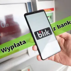 Wyplata z bankomatu za pomocą Blika. Smartfon z logo Blik w dłoni przed bankomatem.