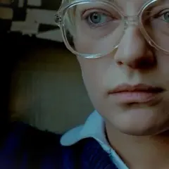 Zbliżenie na twarz kobiety w okularach, przypominającą postać z filmów Barbary Sass.