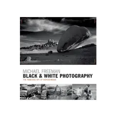 Michael Freeman's "Black & White Photography" showcases the timeless art of monochrome. This cover features a dramatic desert landscape and smaller images of buses, giraffes, and people.