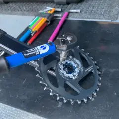 Using a Park Tool torque wrench to ensure proper SRAM chainring bolt torque for a bike repair.