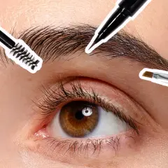 Occhio con ciglia lunghe e sopracciglia truccate, con pennelli per il make-up che definiscono lo sguardo.