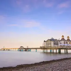 Die Seebrücke im Ostseebad Sellin erstreckt sich ins ruhige Meer. Ein malerischer Anblick bei Sonnenuntergang.