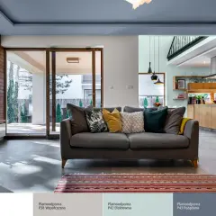 Nowoczesny salon z szarą kanapą i dywanem. Eleganckie łączenie kolorów ścian: dwa kolory ścian w jednym pokoju tworzą przytulną atmosferę.