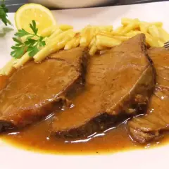 Soczyste bitki wołowe w sosie własnym, podane z makaronem i plasterkiem cytryny. Idealny przepis na obiad.
