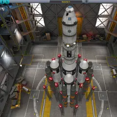 W hangarze Kerbal Space Program spolszczenie: wielka rakieta Kosmo-1 czeka na start.