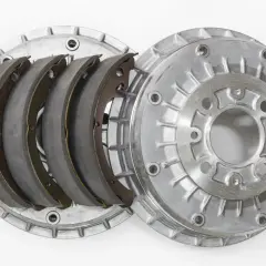 Pièces détachées d'un frein à tambour : mâchoires neuves et tambour en aluminium.