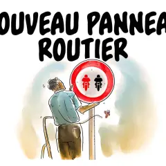 Un homme installe un nouveau panneau routier interdisant les motocyclettes et cyclomoteurs.