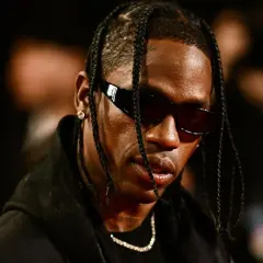 Travis Scott w okularach przeciwsłonecznych, z warkoczykami. Fani w Polsce czekają na jego koncert.