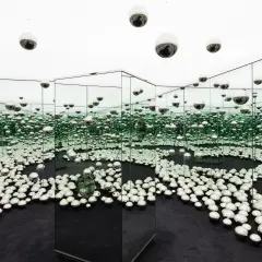 An infinity room filled with mirrored spheres, creating a dazzling, endless reflection at the Rubell Museum Miami.